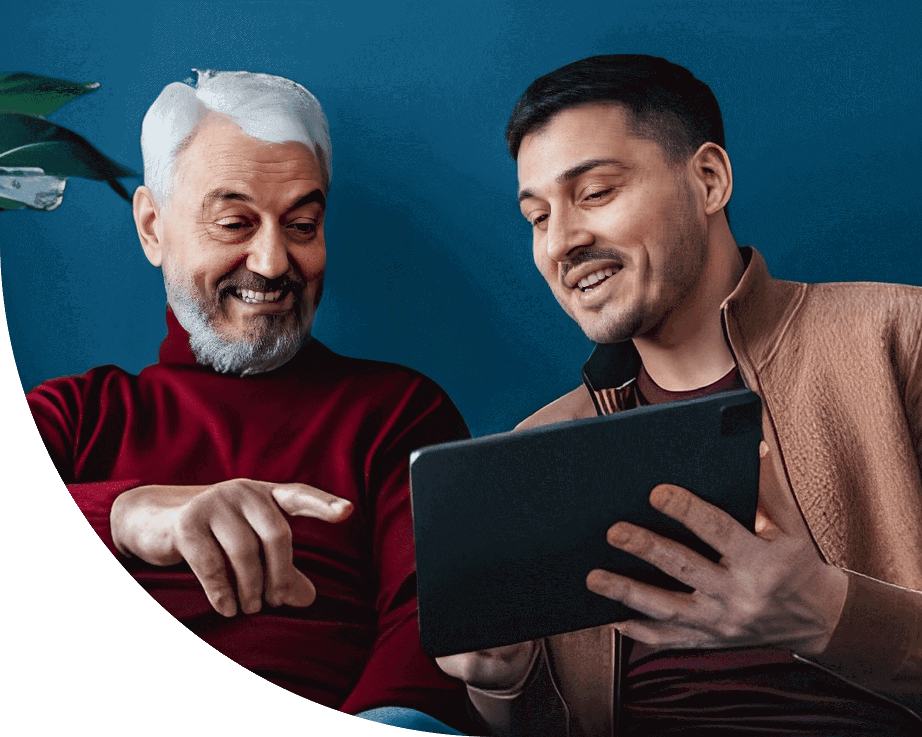 Two men happily looking at a tablet together.